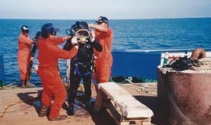 Undressing diver before entry to the chamber for surface decompression breathing oxygen